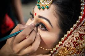 Bride getting makeup done by professional artist